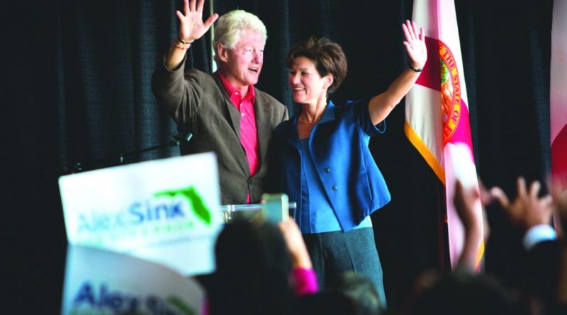 Bill Clinton and Alex Sink waving at the students.