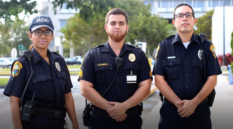 Three public officers posing for the camera.