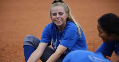 Amber Dalfonso laughing with her teammates.