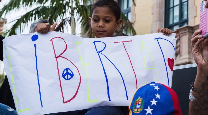 Little boy holding a sign.