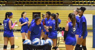 The Lady Sharks volleyball team interacting with each other during practice.